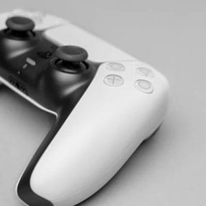 Wireless gaming controller for PlayStation on a white background.